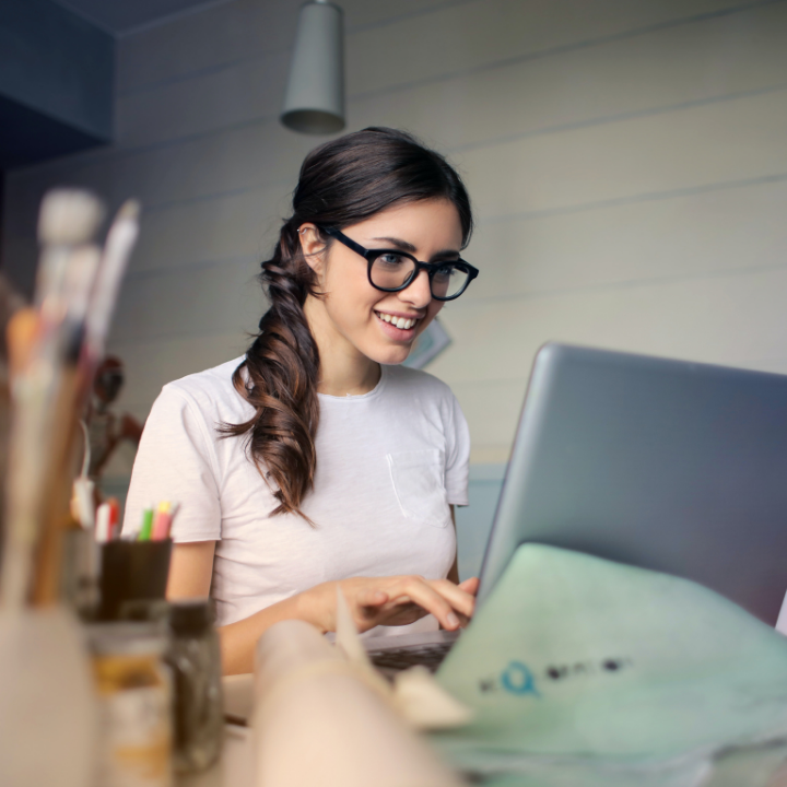 woman in office sitting on a laptop